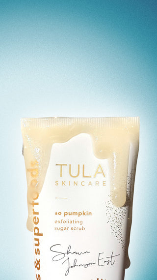 Tula skincare product with a blue gradient background