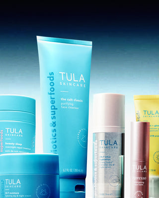 Collection of Tula skincare products on a gradient blue background