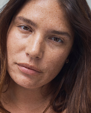 TULA Detox in a Jar Exfoliates and helps even the appearance of skin texture. Model image.