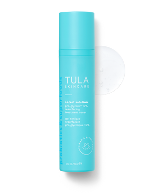A blue bottle of TULA Skincare gel, labeled as 'Secret Solution pH Balancing & Resurfacing Treatment'.