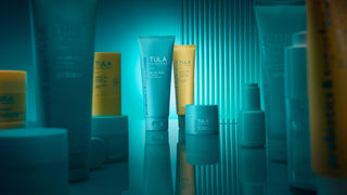Collection of TULA Skincare products on teal background