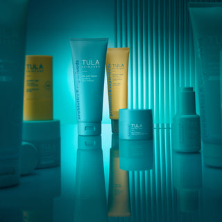 Grouping of TULA Skincare products on blue background. 