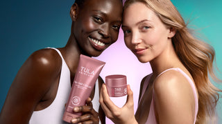 Two women holding Tula products against a gradient background