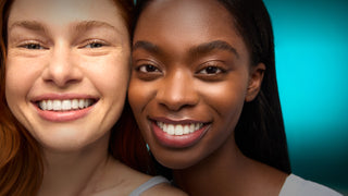 Two women smiling with a blue gradient background