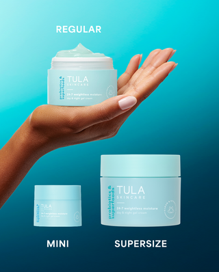 Tula skincare product display with regular, mini, and supersize containers on a gradient blue background.