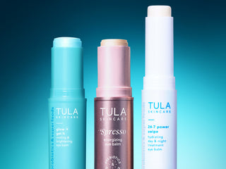 Three Tula skincare products on a gradient blue background