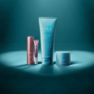 TULA Skincare Products Under a Heart-Shaped Spotlight on Blue Background