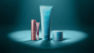 TULA Skincare Products Under a Heart-Shaped Spotlight on Blue Background