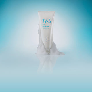 TULA Rich Rinse Cleanser with foam on component on blue background.