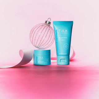 Tula skincare products on a pink background