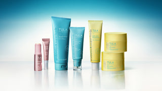 Tula skincare products on a gradient blue background