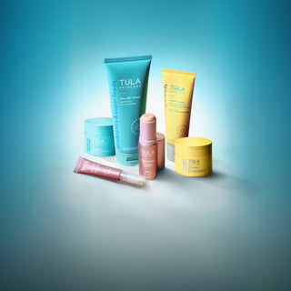Tula skincare products on a gradient blue background