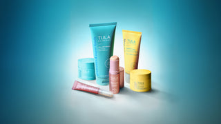 Collection of Tula skincare products on a gradient blue background