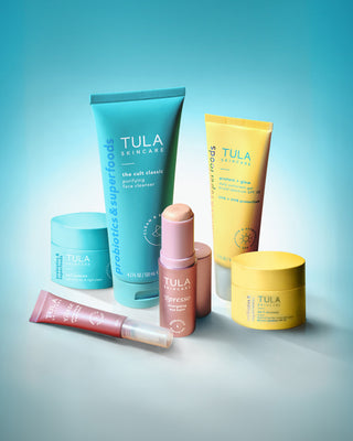 Collection of Tula skincare products on a gradient blue background