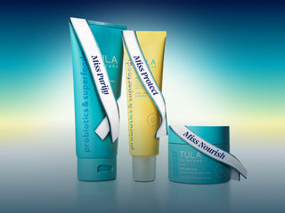 Three Tula skincare products on a gradient blue background