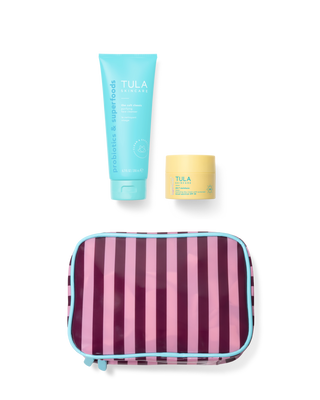 Tula skincare products including a tube and a jar with a striped pouch on a transparent background