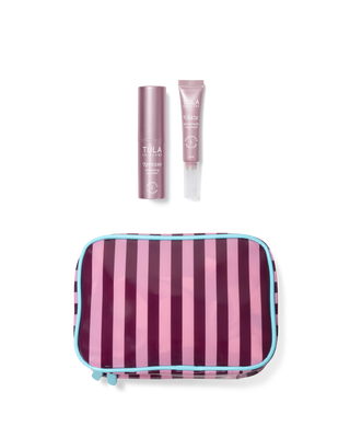 Striped travel pouch with two TULA products on a white background