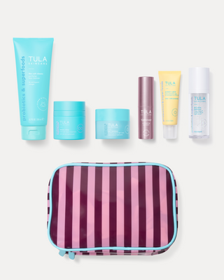 Tula skincare products including bottles, jars, and a striped pouch on a white background