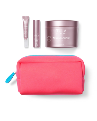Tula skincare products including a jar, tube, and small container with a pink pouch on a white background.