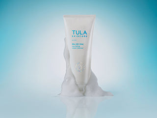 TULA Rich Rinse Cleanser with foam on component on blue background.