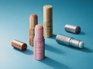 Tula skincare products on a blue background