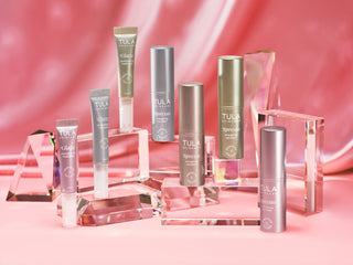 Tula skincare products on a pink background