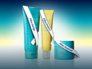 Three Tula skincare products on a gradient blue and yellow background