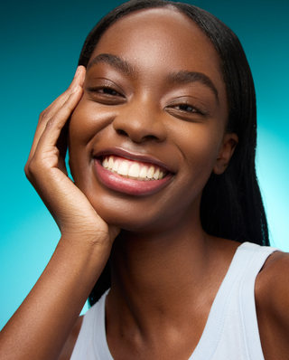 Woman with a bright smile against a blue gradient background