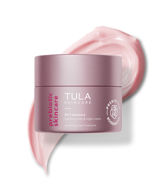 Tula skincare cream jar with pink cream swatch on a white background