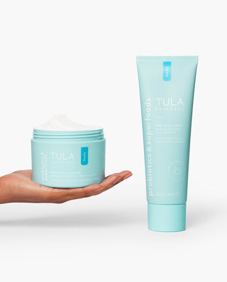 TULA Take Care + Polish - Smoothing and hydrating 2-piece body polish and moisturizer with probiotic extracts. Full size collection displayed in hand for size context.