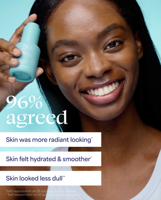 Woman holding a skincare product with text on a light blue background