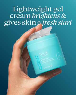 Hand holding a blue Tula product with text about lightweight gel cream on a blue background