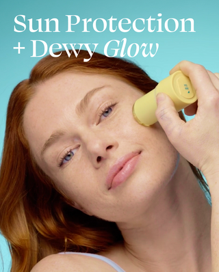 Woman applying a yellow device to her face with text 'Sun Protection + Dewy Glow' on a blue background
