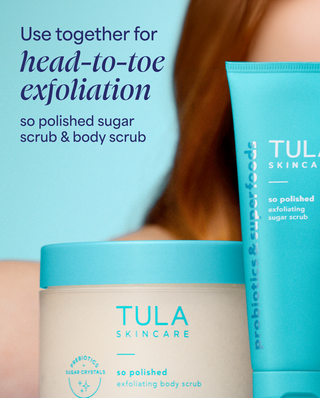 Tula Skincare exfoliating sugar scrub and body scrub with text on a blurred background