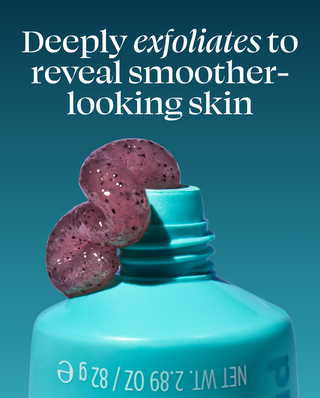 Turquoise bottle with purple exfoliating scrub on a blue background