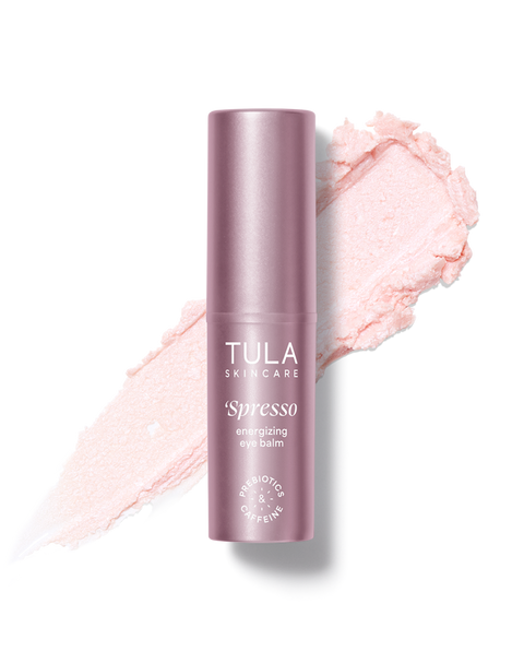 Tula Skincare espresso eye balm with pink makeup swatch on a white background
