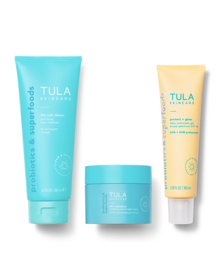 Tula skincare products including a blue tube, a yellow tube, and a blue jar on a white background.