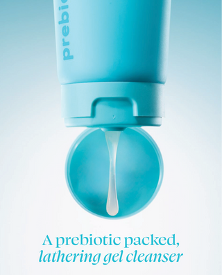 Blue lathering gel cleanser with open cap on a light blue background