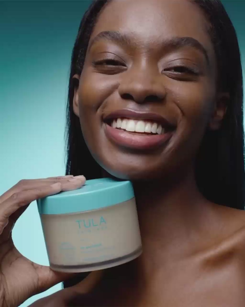 Video of exfoliating sugar scrub in jar and being applied to skin